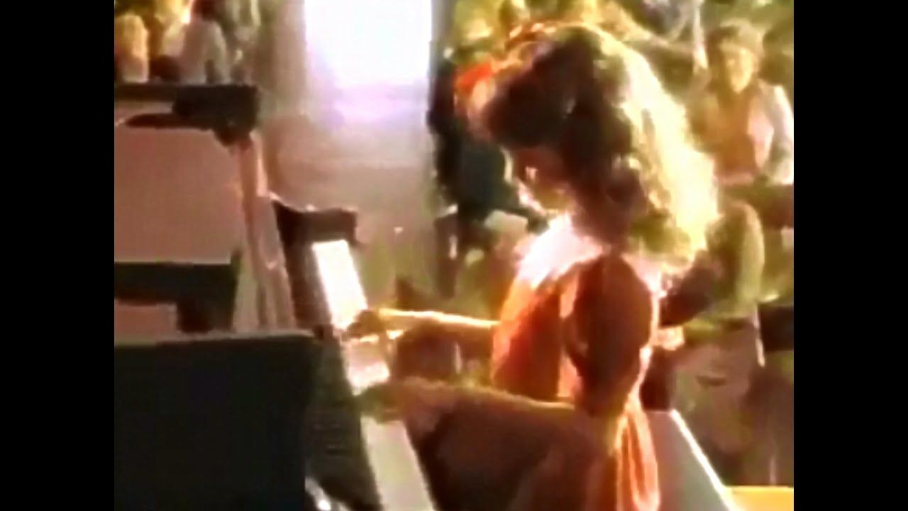 image from an old 1980's McDonald's commercial with a little girl playing the piano at a piano recital wearing a red dress with a big red bow in her hair